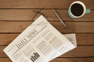 newspaper over wooden table