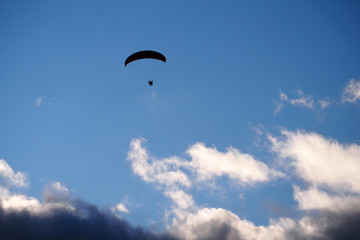Paraglider flies in stormy skies. The glider is a light aircraft plans in the air.    