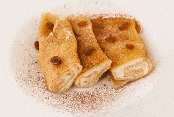 Delicious pancakes with cheese and raisins sprinkled with powdered sugar on (healthy life, sweetie concept)