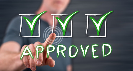 Man touching a validation concept on a touch screen