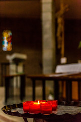 white candle burning amongst extinguished