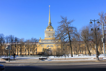 Obraz premium Admiralty Building in St. Petersburg, Russia. Winter Street View of Park and Historic Architecture Building on Sunny Day. Saint Petersburg City Center Landmark, Popular Sightseeing Travel Attraction.