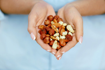 Nuts In Hands. Woman Hands Holding Healthy Food