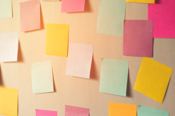 many colorful sticky notes on board background