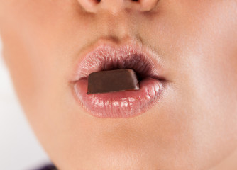 Naklejka premium Woman lips and chocolate