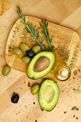 Food Ingredients. Olive Oil With Olives And Avocado On Table