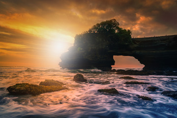 Tanah Lot Temple on sea at sunset in Bali Island, Indonesia.