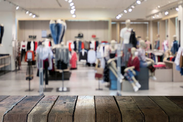 Empty wooden table space platform and blurred clothes shop for display or montage your products