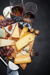 Wine and Various types of cheese - parmesan, brie, roquefort, cheddar - obrazy, fototapety, plakaty