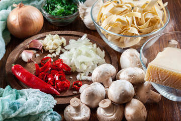 Ingredients ready for prepare tagliatelle pasta with champignon