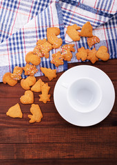 Homemade oatmeal cookies with a cup of tea on old wooden background