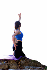 Isolated woman doing yoga exercise on the stone and white background