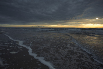 Sunset on the sea from sand beach on the Curonian spit