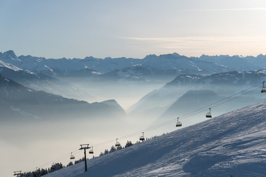 ski resort with ski slopes and lifts and a great view on a sunny winter day in the Alps
