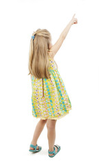 Back view of adorable little girl pointing at wall. Rear view. Isolated on white background