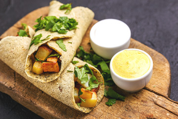 Vegetarian masala dosa with potato, chutney and sambar sauces.