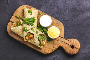 Vegetarian masala dosa with potato, chutney and sambar sauces.
