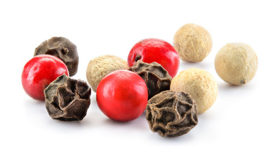 Mix of different peppers. Spice macro. Dry peppercorns isolated on white background. Full depth of field.
