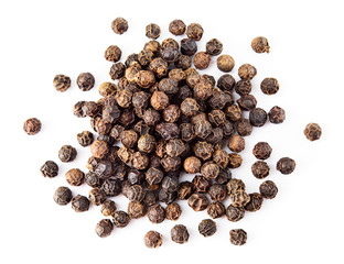 Black pepper. Heap of peppercorns isolated on white background. Macro. Top view.