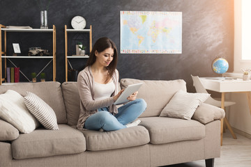 Young woman at home with tablet