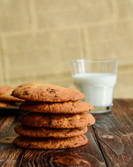 Cookies with chocolate, nuts and a glass of milk.