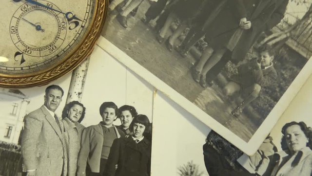 Old 1950's family photo with clock that marks the very fast time.