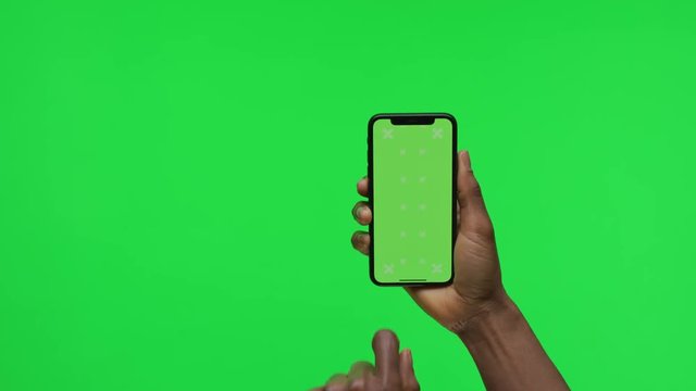 Female Hand holding Green Screen Smartphone and Scrolling Up