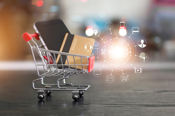 Online shopping. Gold credit card and smartphone in small shopping cart with customer icons network...