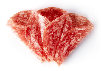 Sliced summer sausage on white background, from above