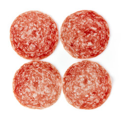 Sliced summer sausage on white background, from above