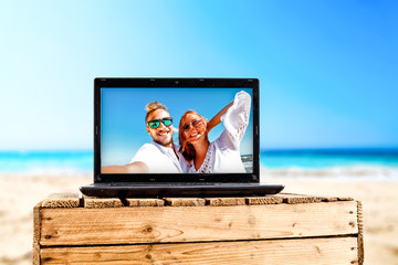 summer time and black laptop on beach 