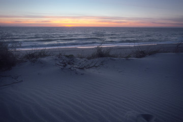 Sunset on the sea from sand beach on the Curonian spit