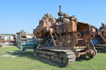 Old rusty disassembled combine harvester. - obrazy, fototapety, plakaty