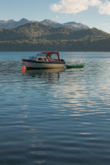 Fototapeta na wymiar Boat on the Nahuel Huapi Lake in Patagonia with the Andes Mountains in the background
