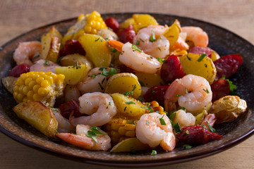 Shrimps with sausages, new potatoes and sweet corn. One sheet pan shrimps with sausages and vegetables