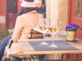 Two glasses of white wine served in a small cafe in the Old Town of Porto, Portugal.