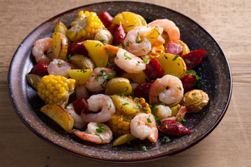 Shrimps with sausages, new potatoes and sweet corn. One sheet pan shrimps with sausages and vegetables
