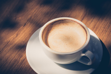 cup of coffee  on table in cafe in dark tone and vintage