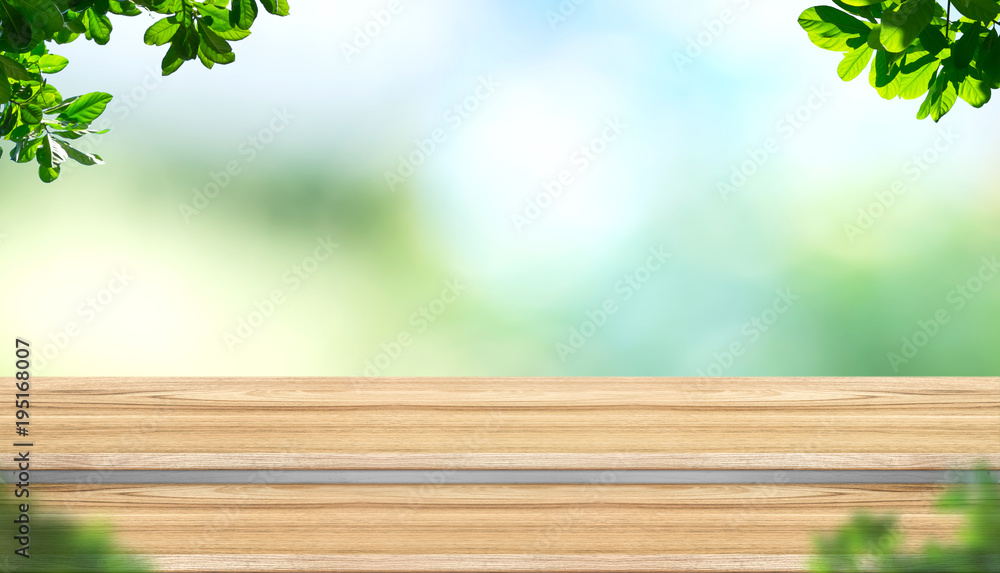 Fototapete empty step plank wood table top with blur tree in park with bokeh light background and leaves foregr