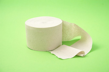 roll of toilet paper on a green background.