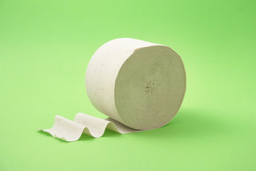 roll of toilet paper on a green background.