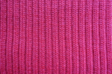 Fototapeta na wymiar Rose red knitted fabric with ribs from above