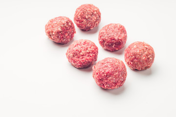 Meat balls from raw beef force-meat on a white