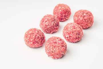 Meat balls from raw beef force-meat on a white