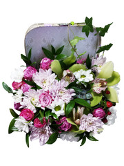 Bouquet of flowers in a suitcase. Arrangement of flowers from roses, chrysanthemums and orchids