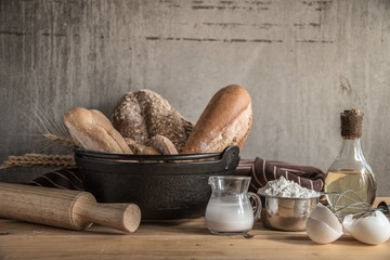 Different kinds of bread rolls on table wooden from above. Kitchen or bakery poster design