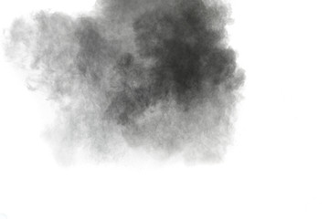 Black powder explosion against white background.The particles of charcoal splattered on white background. Closeup of black dust particles explode isolated on white background.