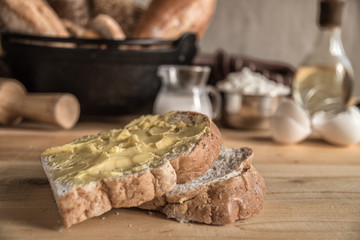 Different kinds of bread rolls on table wooden from above. Kitchen or bakery poster design