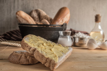 Different kinds of bread rolls on table wooden from above. Kitchen or bakery poster design