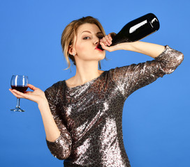 Winetasting concept. Girl with tricky face drinks expensive cabernet